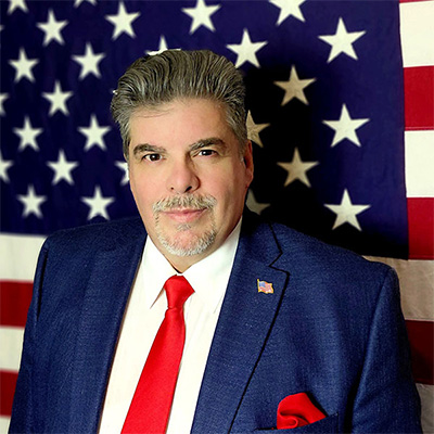 paul romero for governor in a blue suite and red tie